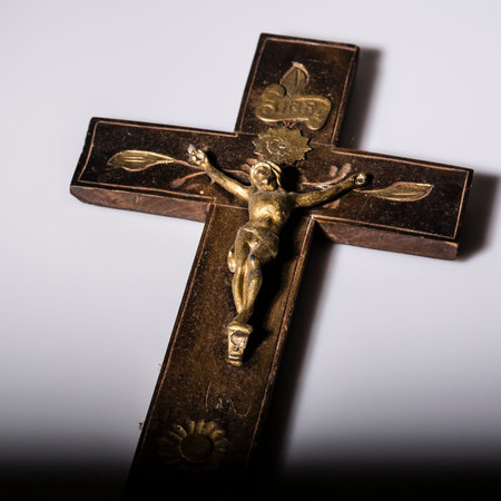 Old wooden Crucifix with figure of Jesus on white background
