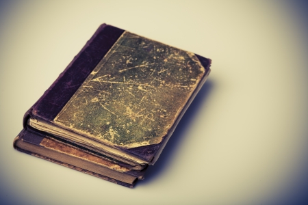Beautiful old brown and green books closeup on white の写真素材