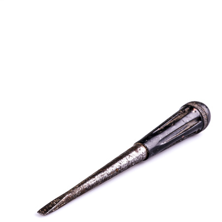 Old rusty black screwdriver on white backgroundの写真素材