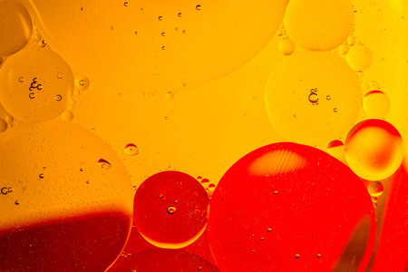 Oil drops on a water surface with color backgroundの写真素材