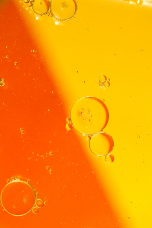 Oil drops on a water surface with color backgroundの写真素材