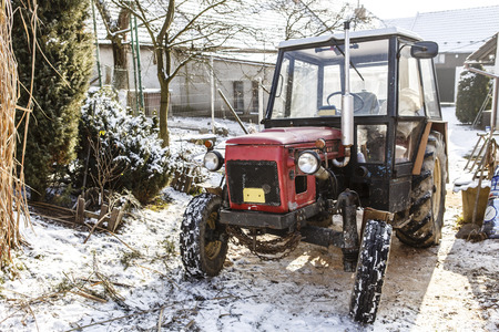 Old red Czech tractor on the snow - in the yard and winterのeditorial素材