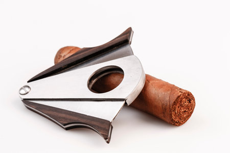 Expensive cigar and cutter on a white backgroundの写真素材