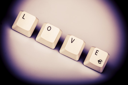 Word love formed with computer keyboard keys on white background with shadowの写真素材