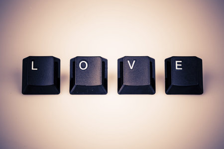 Word love formed with computer keyboard keys on white background with shadow