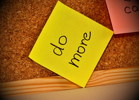 Cork notice board with sticky note pad with text do more
