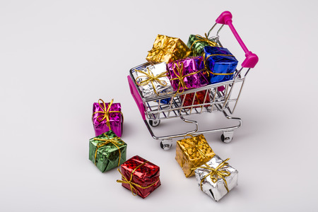 Christmas gifts in shopping cart, isolated on white. ready for christmasの写真素材