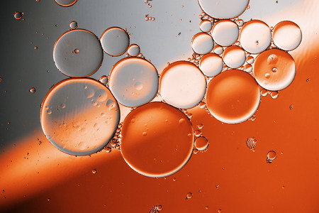 Oil drops on a water surface with color backgroundの写真素材