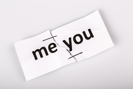 "me you" words written on torn and stapled paper on whiteの写真素材