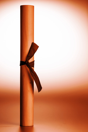 retro rolled paper on the old wooden tableの写真素材