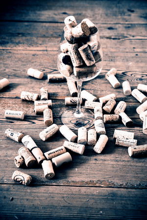 vintage cork from wine bottle and glass on the wood floorの写真素材