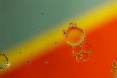 Oil drops on a water surface with color background