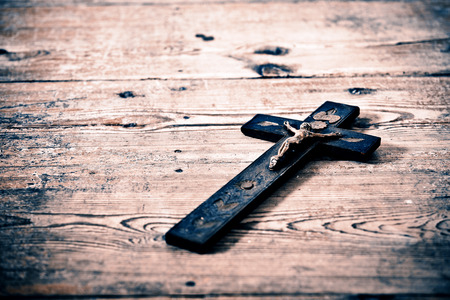 Beautiful old cross with jesus on the old wooden floorの写真素材