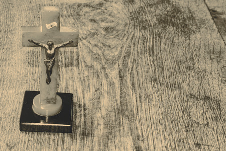 Beautiful old cross with jesus on the old wooden floorの写真素材