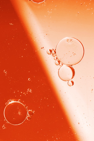Oil drops on a water surface with color backgroundの写真素材