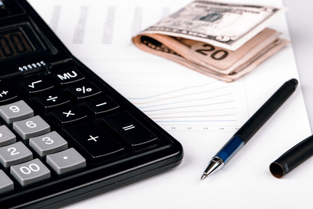 Business Charts with calculator, dollars money and pen on white backgroundの写真素材