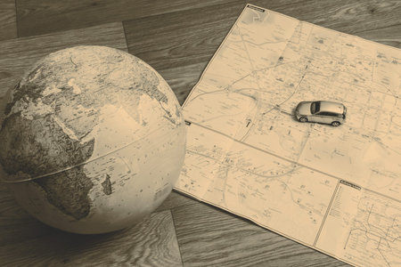 blue globe and car and map of earth on the wooden floor