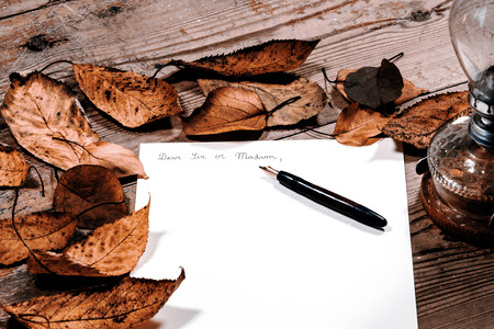 Old fashioned letter with a pen and leafsの写真素材