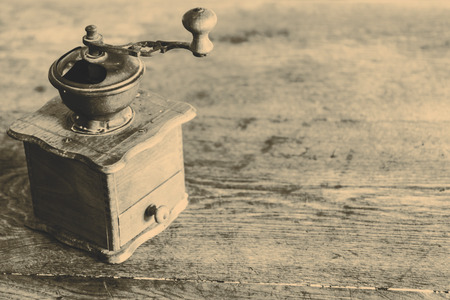 Vintage manual coffee grinder on the old wooden tableの写真素材