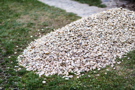 big pile of grey stones on the grassの写真素材