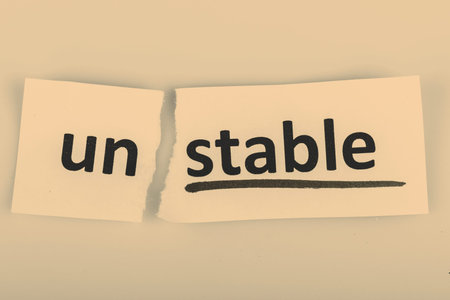 The word stable changed to unstable on torn paper and white background