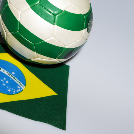 green and white football ball on the brazil flag - white background, brasilの写真素材