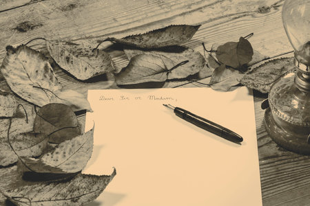 Old fashioned letter with a pen and leafsの写真素材