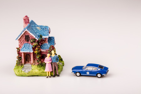 happy man and wife with blue car and new house, real estate, mortgageの写真素材