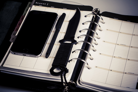 plan for murderer - calendar, planner, cellphone, pen and knife as weaponの写真素材