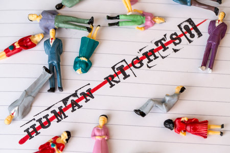 no human rights, strikethrough text on paper in retro style with lying people aroundの写真素材