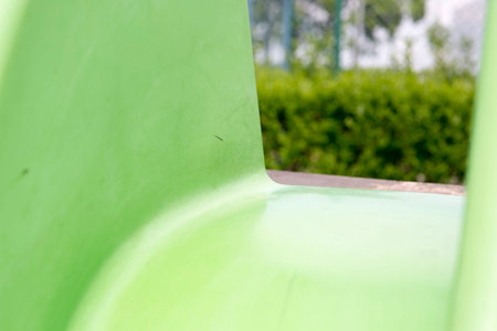 Green child slide on playground, entertaiment tool