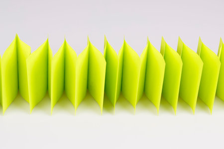 abstract green paper fence on white - sticky notes paper