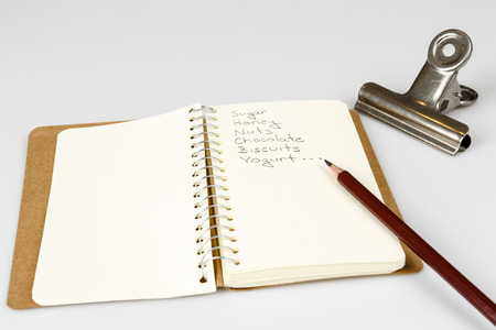 shopping list in the diary with pencil on whiteの写真素材