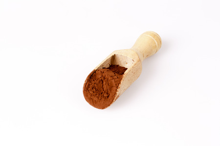 old wooden spoon with coacoa or cacao on whiteの写真素材