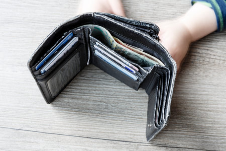 open black woman wallet with money and id cards on the wooden table