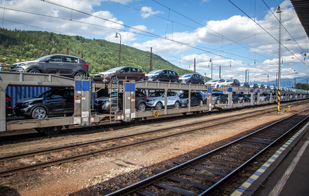 ZILINA, SLOVAKIA- JUN 23: Train full of new cars from near factory KIA at the railway station in city Zilina on Jun 23, 2014 in Zilinaのeditorial素材