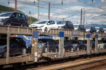 ZILINA, SLOVAKIA- JUN 23: Train full of new cars from near factory KIA at the railway station in city Zilina on Jun 23, 2014 in Zilinaのeditorial素材
