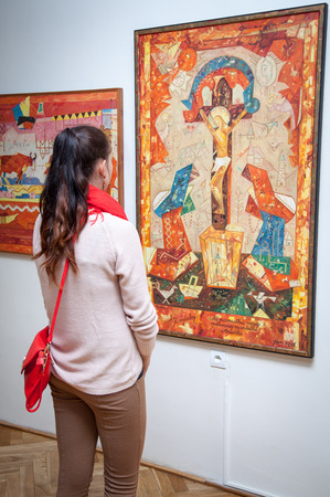 RUZOMBEROK, SLOVAKIA - JULY 22: Girl looking at Fulla's painting in Gallery of Ludovit Fulla on July 22, 2014 in Ruzomberokのeditorial素材
