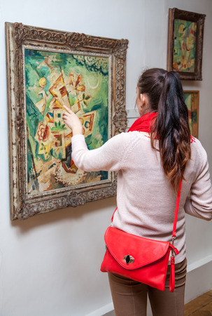 RUZOMBEROK, SLOVAKIA - JULY 22: Girl looking at Fulla's painting in Gallery of Ludovit Fulla on July 22, 2014 in Ruzomberokのeditorial素材