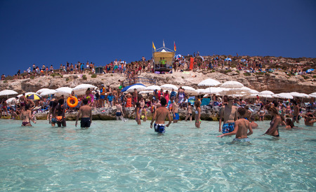 COMINO, MALTA - JULY 16: Sunbathing at  Blue lagoon at island Comino - Malta on July 16, 2015 in Cominoのeditorial素材