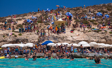 COMINO, MALTA - JULY 16: Sunbathing at  Blue lagoon at island Comino - Malta on July 16, 2015 in Cominoのeditorial素材