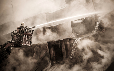 Fireman and burnt roofの写真素材