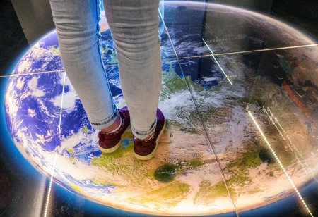 Walking on globe - planet earthの写真素材