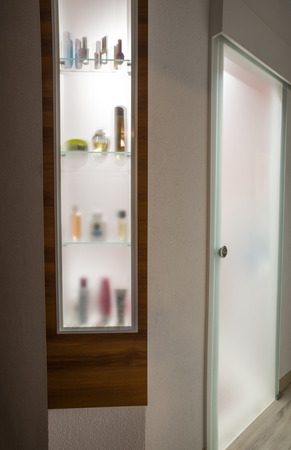 Wooden glazed shelf with backlightの写真素材
