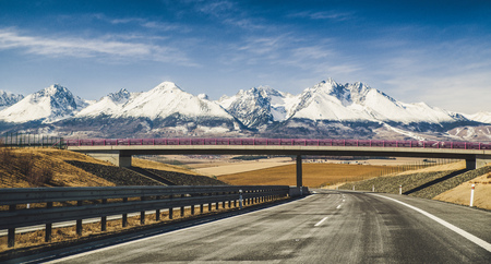 Empty highway D1 and snowy peaks of High Tatras mountains, Slovakiaの写真素材