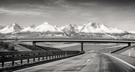 Empty highway D1 and snowy peaks of High Tatras mountains, Slovakiaの写真素材