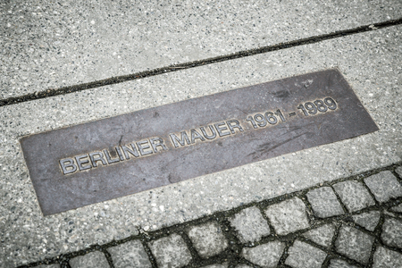 BERLIN, GERMANY - APRIL 7: Memorial board of Berlin wall on pavement on April 7, 2017 in Berlinのeditorial素材