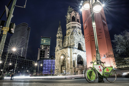 BERLIN, GERMANY - APRIL 7: Traffic and ruins of Kaiser Wilhelm Memorial Church which was bombed during World war II on April 7, 2017 in Berlinのeditorial素材
