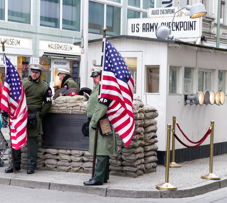 BERLIN, GERMANY - APRIL 7: Checkpoint Charlie - Berlin Wall crossing point between East and West Berlin during the Cold War on April 7, 2017 in Berlinのeditorial素材