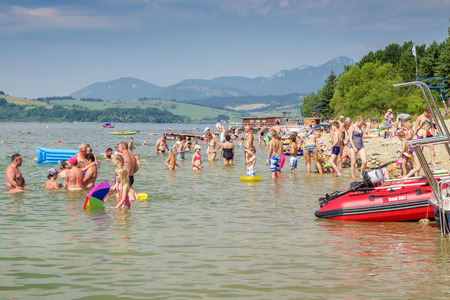 LiPTOVSKY TRNOVEC, SLOVAKIA - AUGUST 2: People relaxing and sunbathing on shore of water reservoir Liptovska Mara on August 2, 2017 in Liptovsky Trnovecのeditorial素材